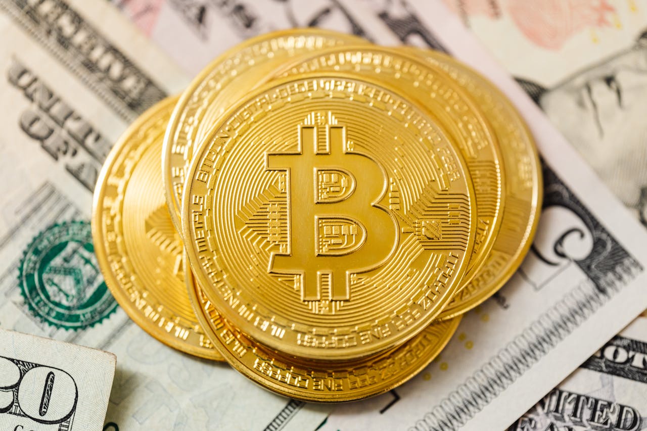 Services Detailed view of golden Bitcoin coins atop US dollar bills, symbolizing cryptocurrency investment.