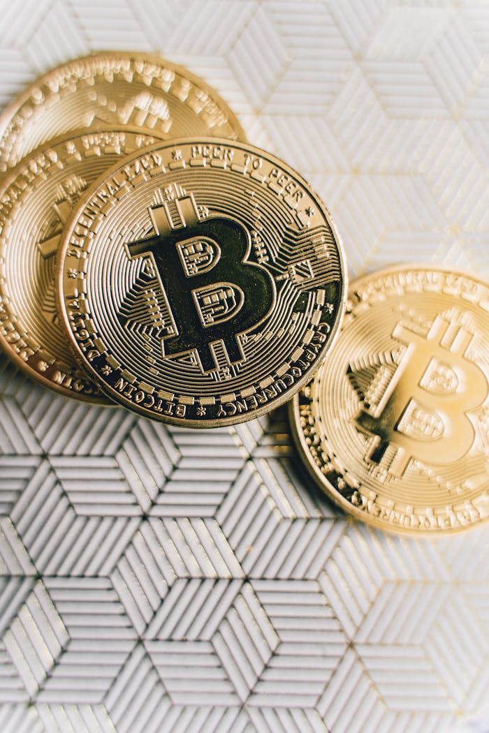 About Close-up of Bitcoin coins placed on a geometric patterned surface, representing cryptocurrency and finance.